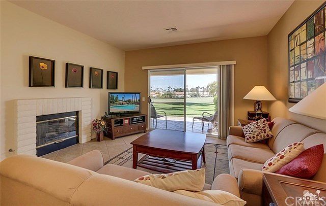 Living room with gas fireplace and patio access