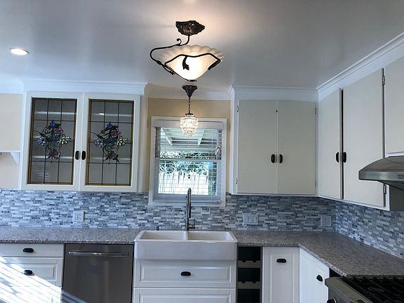 Kitchen with Stainless Steel appliances, gas stove, farm sink, quartz counter tops.