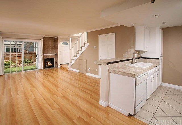 The spacious living room is drenched in natural li