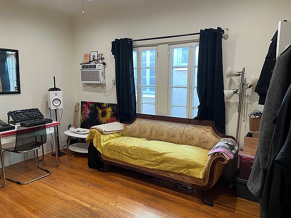 bedroom for rent window for natural light and AC unit to the left works well to get the room cool quick