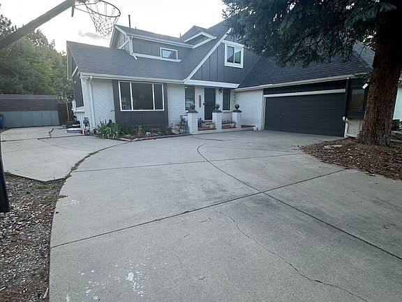 Front of house with RV parking and basketball hoop