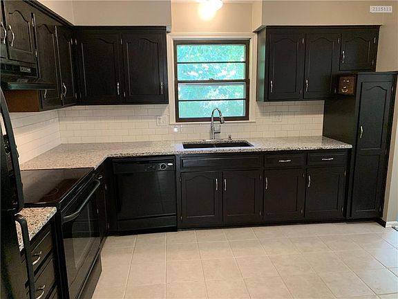 Updated kitchen with granite counter tops and tile backsplash