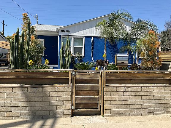 Closer front view of the house from outside the gate