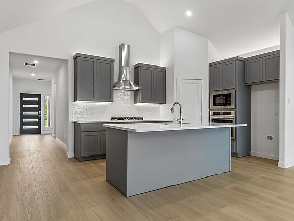 Kitchen in the Claret home plan by Trophy Signature Homes - REPRESENTATIVE PHOTO