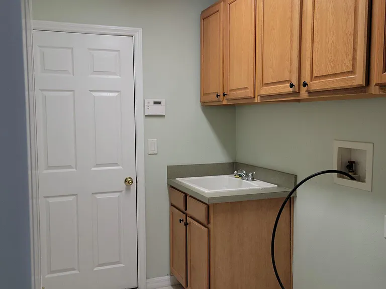 Laundry Room with washer and dryer attachments.