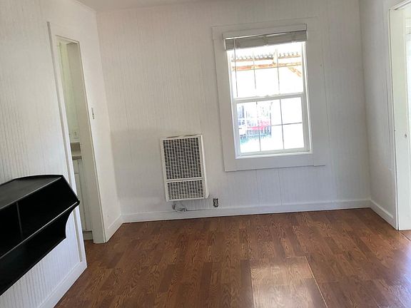 View from front door facing backyard and kitchen doorway on right 2nd bedroom entry on right. Black TV shelf mounted