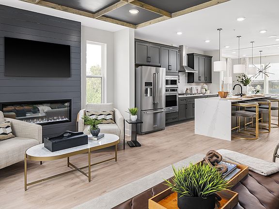 Open main level family room and kitchen in a DRB Homes Rockland model at the Locke Landing community