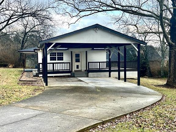 Corner lot, driveway into carport/kitchen entry.