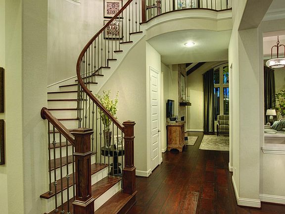 Foyer with chandelier, staircase and hardwood floors