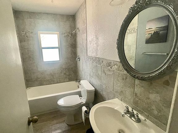 large tub and bathroom with ceramic tile