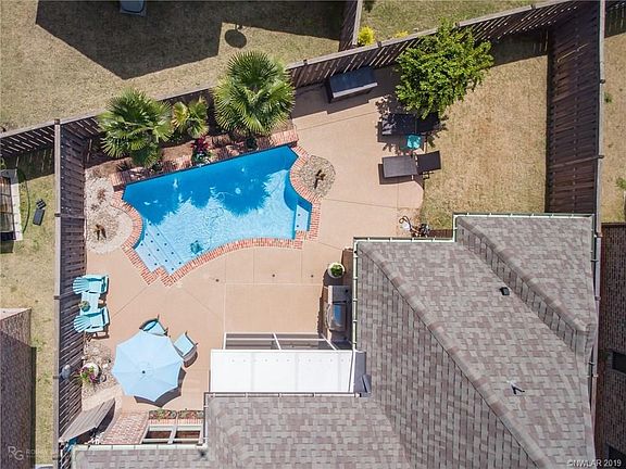 This is a great view of the outside oasis that awaits you.  The screened in back patio leads to the swimming pool.