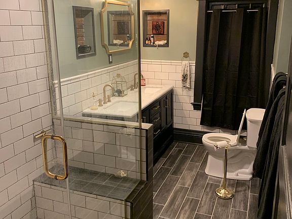 Newly renovated bathroom with large tiled shower.