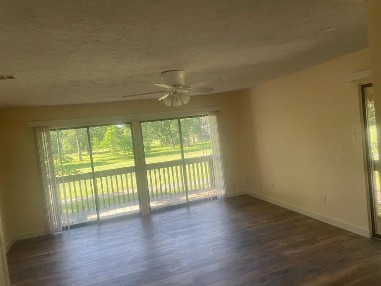 Living room w sliding door(s) to covered balcony deck