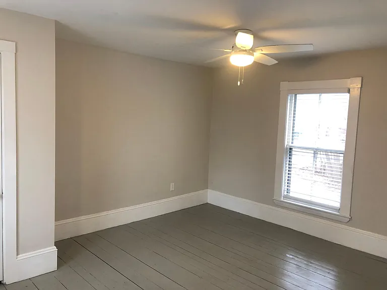 Upstairs bedroom with windows on both sides.