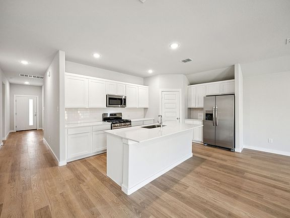 Kitchen in the Emmy II home plan by Trophy Signature Homes - REPRESENTATIVE PHOTO