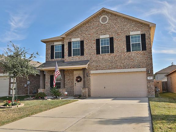 LOVELY FRESH LANDSCAPING DETAIL - Front view offers eye catching brick & stone exterior with a double-wide drive for ease of parking.