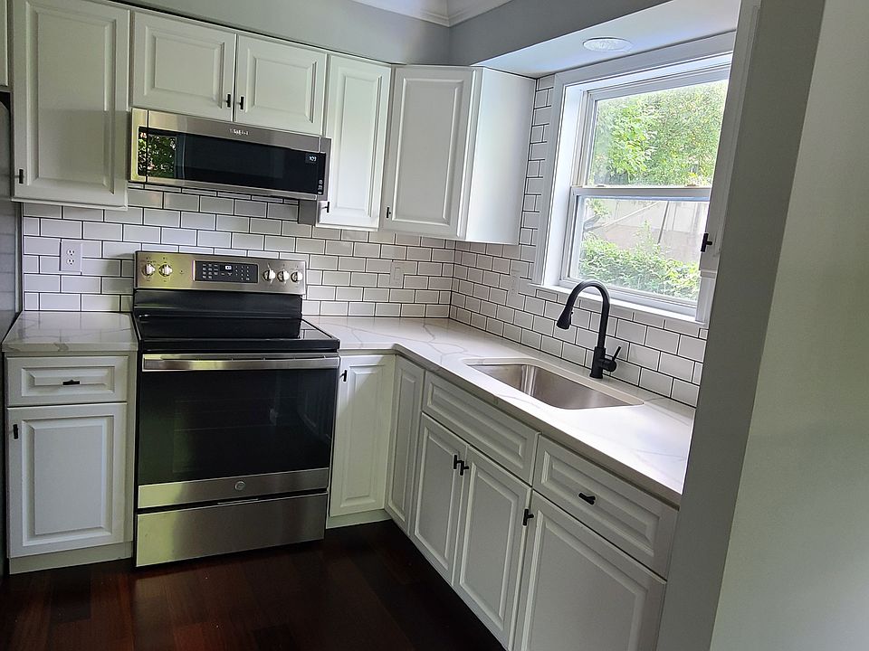 Updated kitchen with quartz counters & tile backsplash; stainless steel appliances