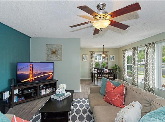 LIVING ROOM AND DINING ROOM. NOTICE THE LARGE WINDOWS
