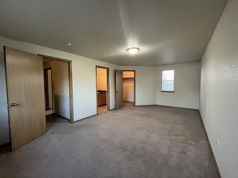 Owner suite bedroom with doors to walk in closet and private bathroom
