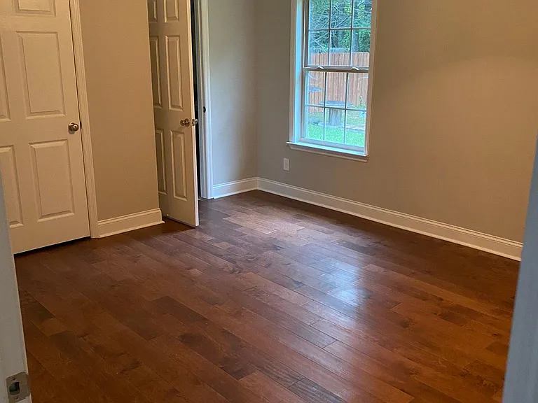Main Bedroom With Hardwood Flooring