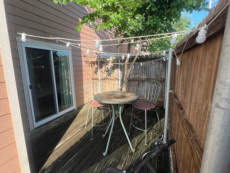 Private fenced back patio showing sliding glass door from main bedroom