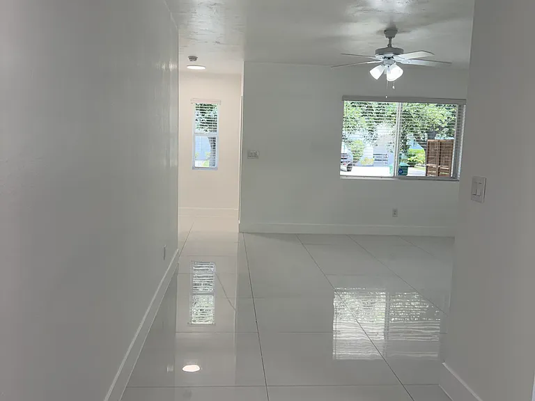 A view from the back of the home looking through the open floor plan to the front entrance.