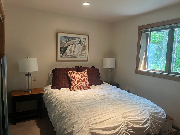 Second queen bedroom off hallway entry level by family room.
