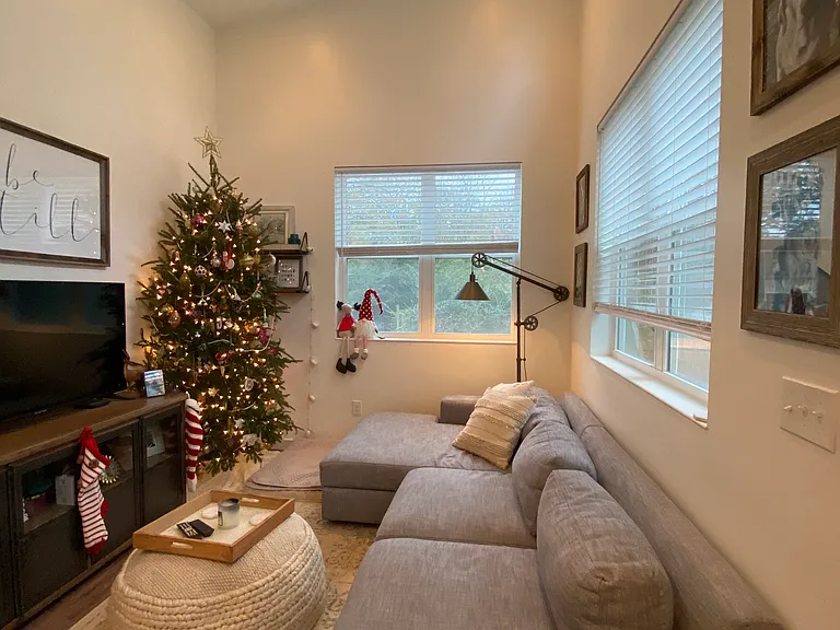High ceilings with natural light in both living room and kitchen.