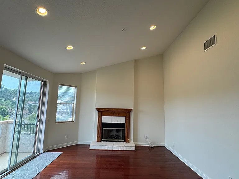 Family Room with gas Fireplace and balcony that spans the entire width of the house. Great for outdoor entertaining.