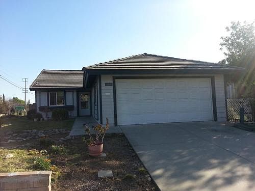 FRONT VIEW W/ ENTRANCE TO THE LEFT & 2-CAR GARAGE TO THE RIG
