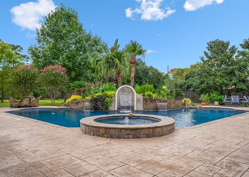 Welcome to superior living at 9619 Stonebridge Place! Here is a gorgeous sneak peak at the backyard paradise! But let's check out the curb appeal in the front before we head inside to see all the wonderful things this custom home has to offer!