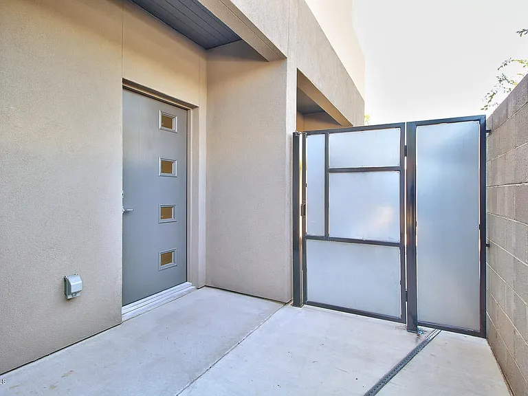 Modern front door and side gate to private backyard.