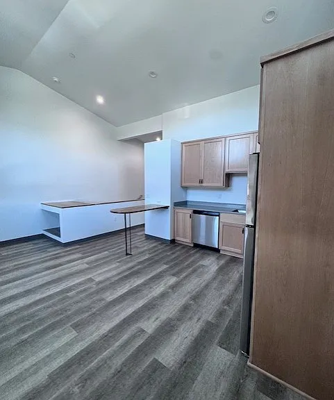 view from far corner of living space looking toward the stairwell