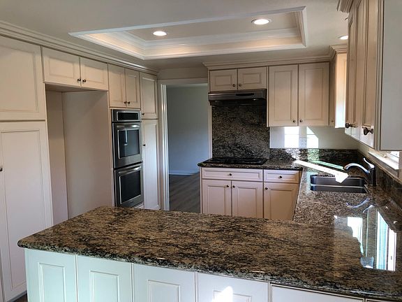 Granite kitchen counters with lots of storage.