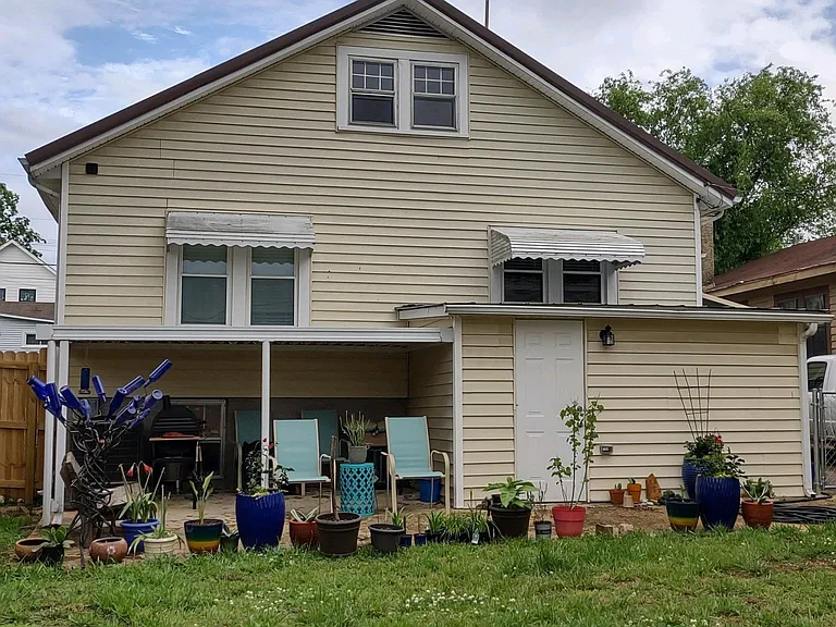 Fenced backyard with covered back porch