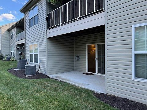 Backyard patio opens up to large back yard maintained by the association