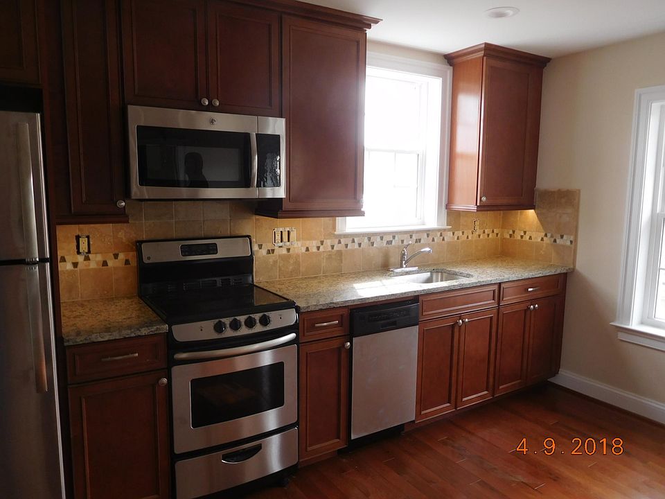 Brand new kitchen with granite counter top, tile back-splash