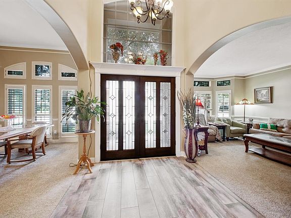 Grand foyer entrance with porcelain tile (wood-look) floor
