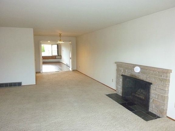 Massive living/dining area with one of three brick fireplaces.