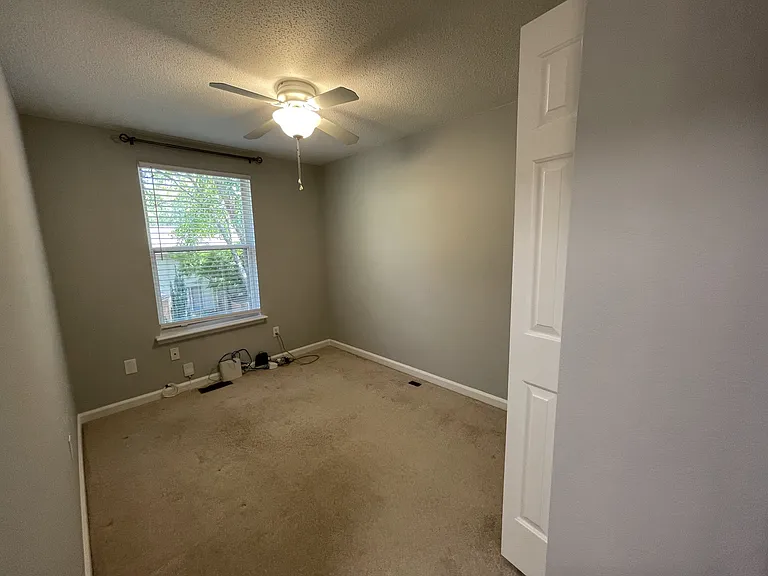 Third bedroom/office with ceiling fan, room darkening blinds, and curtain rod