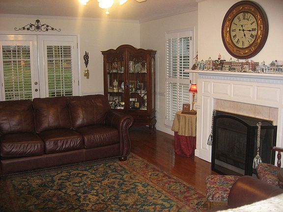 Inviting LR with fireplace, crown molding, fr. doors to porch