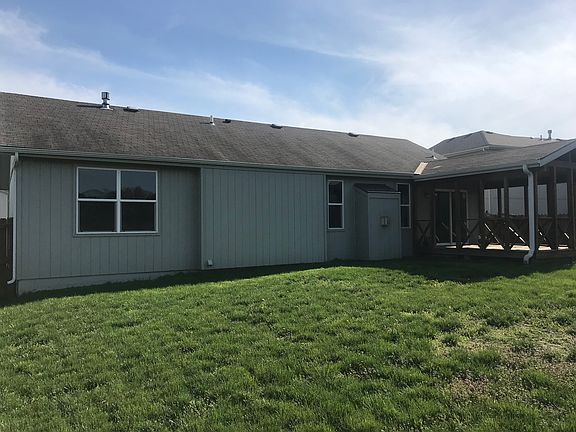 back of house with deck