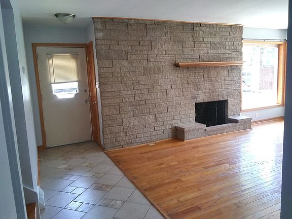 Open foyer to large living room with stone wood burning fireplace! Gleaming hardwood floors. Just pa