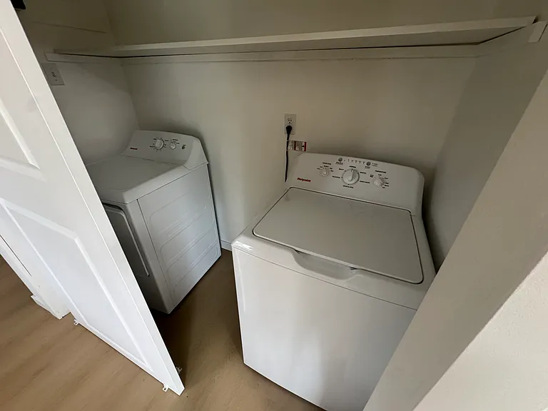 Full-size in-unit washer and dryer conveniently located near the kitchen for added everyday convenience.
