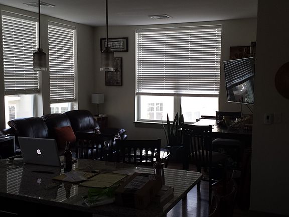 Living room, partially furnished aparment, with table and co