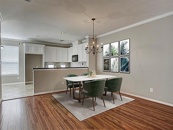 Dining area on the second floor leads into the kitchen. Virtually staged.