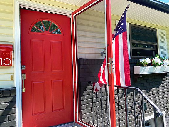 Close-up front door with interchangeable screen door and storm door.