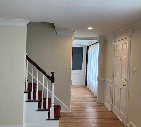 Entryway, standing in living room looking into dining room.