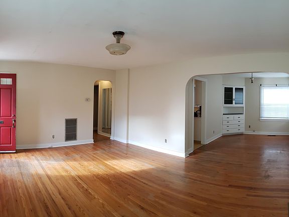 Panoramic view of living and dining rooms. Hardwood floors.