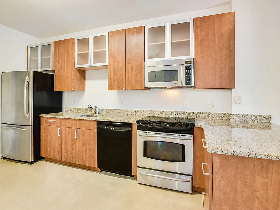Renovated kitchen with granite countertops and stainless steel appliances
